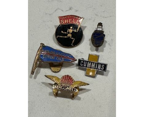 Five petroliana badges inc. enamel: Shell Lubrications depicting the stick man or robotoman, Champion spark plug, Aeroshell, 