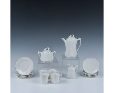 This gorgeous set is made of fine bone china or porcelain, featuring an elegant Art Nouveau style. The set includes a lidded 