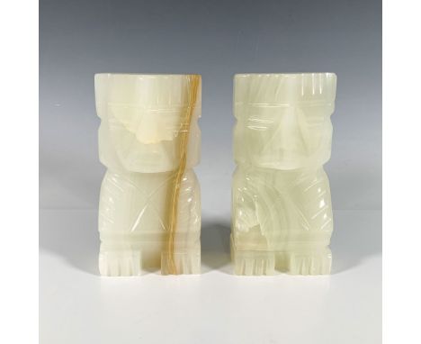 An exquisite pair of sculptural bookends crafted from a milky-hued stone, featuring intricately carved tribal indigenous figu