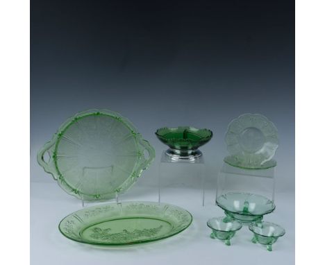 This charming collection of vintage green glassware features eight beautifully crafted pieces. Included are three items in th