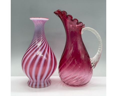 Features an opalescent swirl pink vase and a pink pitcher with a scalloped edge and clear handle. Largest measures 7"L x 5.5"