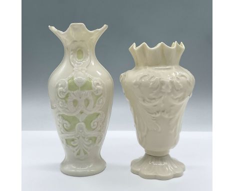 Two glossy cream colored vases with delicate raised designs. One features light green and gilded gold accents, the other an i