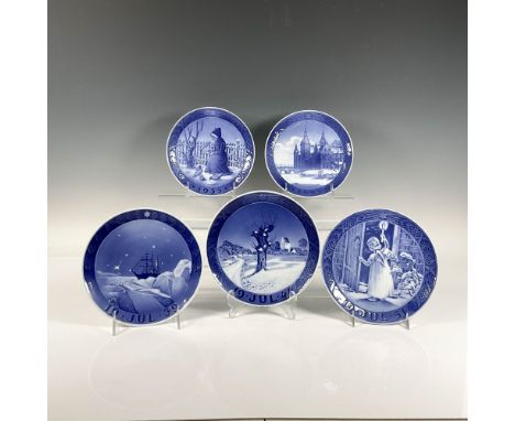 A set of 5 exquisite blue plates, each capturing a unique winter scene with a woman feeding a bird, a leafless tree blanketed