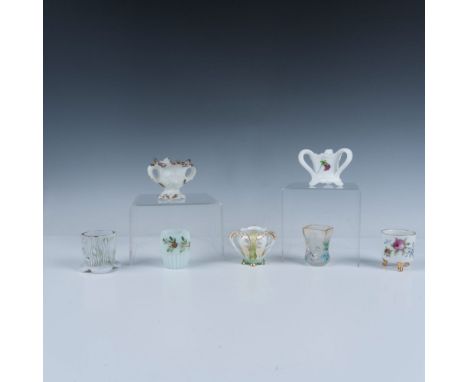 A stunning collection of seven toothpick holders all beautifully decorated with floral or nature inspired designs, including 