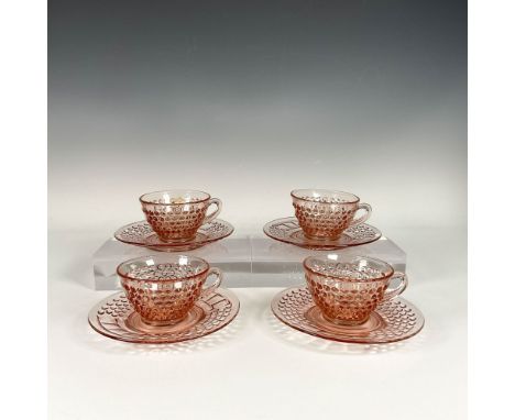Set of Depression style pink glass coffee cups and saucers, adorned with protruding dot patterns covering the entire surface.