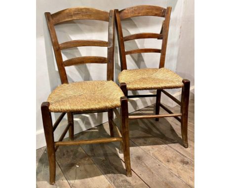 Pair of provincial ladder back country chairs, with strung seats 