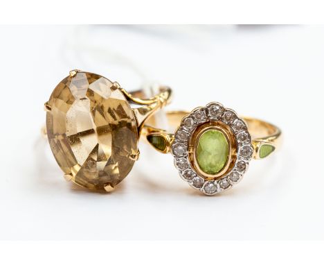 Two 9ct gold dress rings comprising a peridot and diamond ring, size Q, along with an oval citrine version, size N, combined 