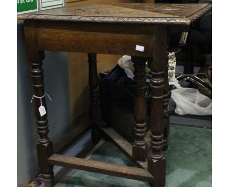 A late Victorian oak carved gate leg table of triangular form