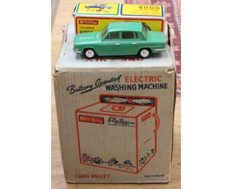 A boxed Triumph 2000 The Lucky Toys car, complete with suitcases and roof rack, with a battery operated washing machine by Ch