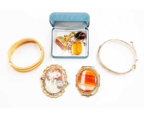 A collection of Victorian jewellery including a gilt metal cameo brooch, gilt metal and banded agate brooch, bangle with gran