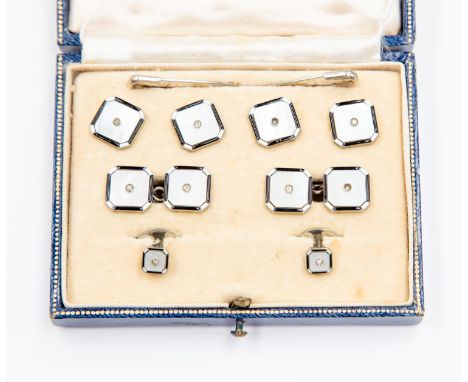A set of mother of pearl white metal collar studs and buttons, mother of pearl set with small stones set to the centre, black