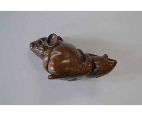 A treen netsuke of a rat with a squid, signed 