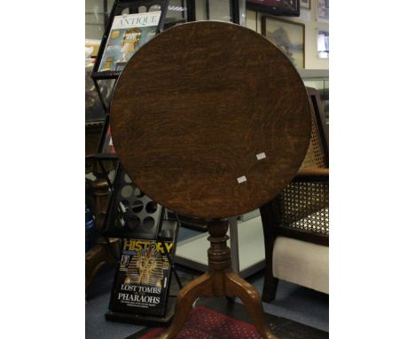 A George III Oak Tilt Top Table on Cabriole tripod supports.