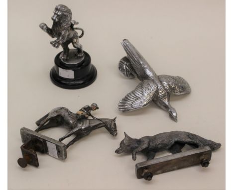 Four various white metal car mascots by Le Jeune including; racehorse with jockey up (enamel colours); a fox; a lion rampant 