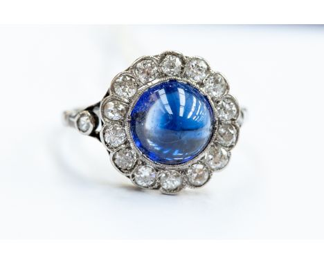 A vintage diamond and sapphire ring comprising a cabochon sapphire ring, the sapphire approx 8mm  with a diamond collect set 