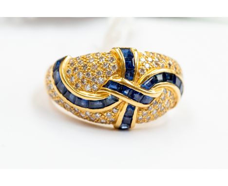 A sapphire and diamond boule head ring, comprising baguette and square cut sapphire and round brilliant cut diamonds, contine