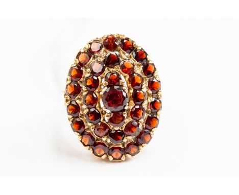 A 9ct gold and garnet oval cluster ring, size L, gross weight approx 5.9gms