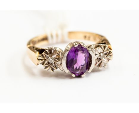 A 9ct gold and amethyst ring, white gold setting with two diamond chips, size I, goss weight approx 3.2gms