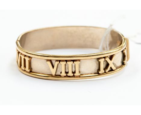 A 9ct gold two tone bangle white gold with applied yellow gold Roman numerals and yellow gold edges, internal diameter approx