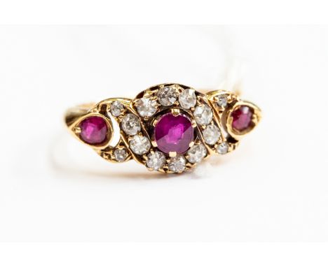 A Victorian ruby and diamond three stone ring, three rubies with diamond set borders rose gold, size J½, total gross weight 3