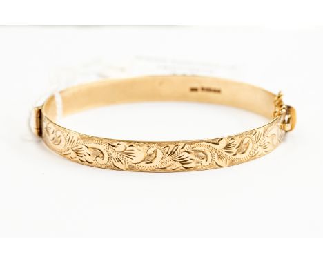 A 9ct gold bangle, foliate engraved decoration, approx 15gms