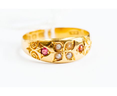 A Victorian ruby and seed pearl ring, scroll decoration, 18ct gold, size R, total gross weight approx. 3.2gms.