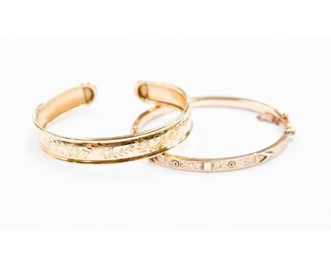 Two 9ct gold bangles, comprising one hinged version and a torque bangle, combined weight approx 16 grams