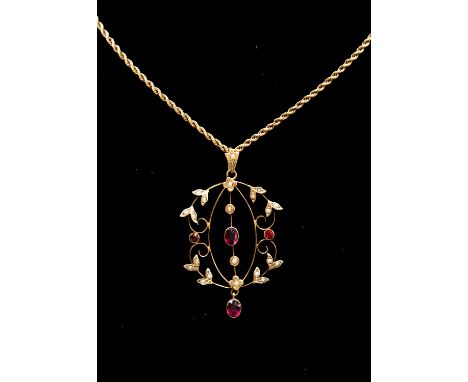 An Edwardian open work pendant set with seed pearls and red paste, floral accents on rope chain, unmarked gold probably 9ct g