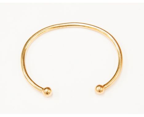 A 9ct gold torque bangle, ball ends, weight approx. 14.8gms.