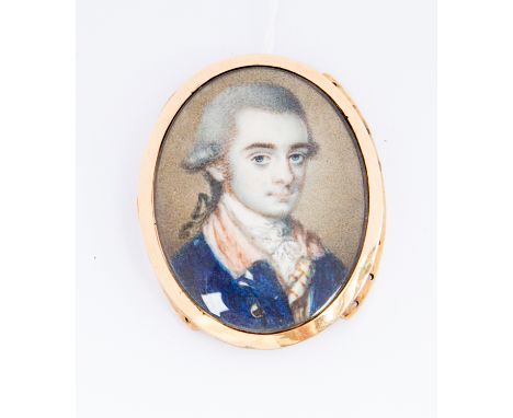 A George III oval portrait miniature of a young dandy, wearing  white stock and a blue tunic, on ivory, set in a yellow metal