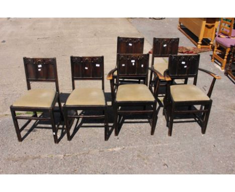A Set of Six Dark Elm Ercol Dining Chairs, two carvers and four chairs. (6)