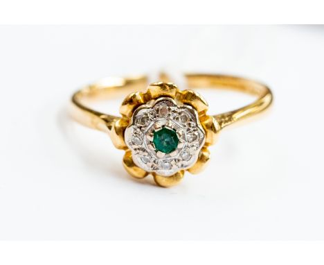 An 18ct gold emerald and diamond chip cluster ring, size O, gross weight approx 3.5gms