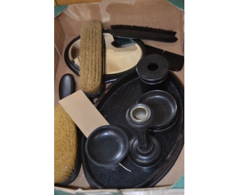An early 20th Century ebony dressing table set, comprising tray, hair pin box, candlestick, three brushes, two pin trays, ped