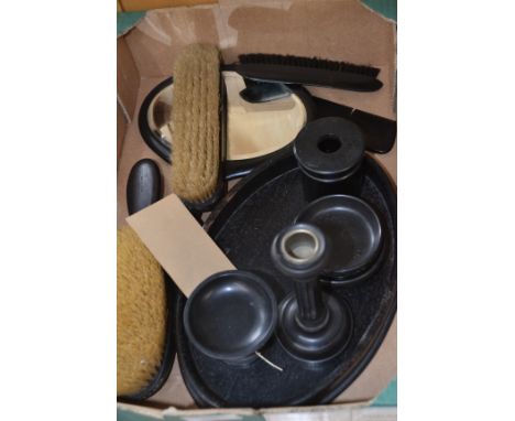 An early 20th Century ebony dressing table set, comprising tray, hair pin box, candlestick, three brushes, two pin trays, ped