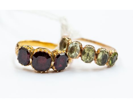 A 19th century gold and garnet three-stone ring, size M, unmarked tests as approx 15ct gold, approx 3.2gms, closed back setti