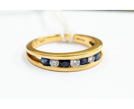 A sapphire and diamond half eternity ring, channel set with seven stones, size N, 18ct gold, total gross weight approx. 4.5gm
