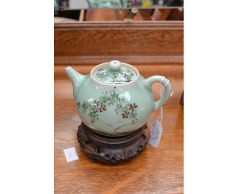 Chinese pale green glazed teapot on wooden stand A/F