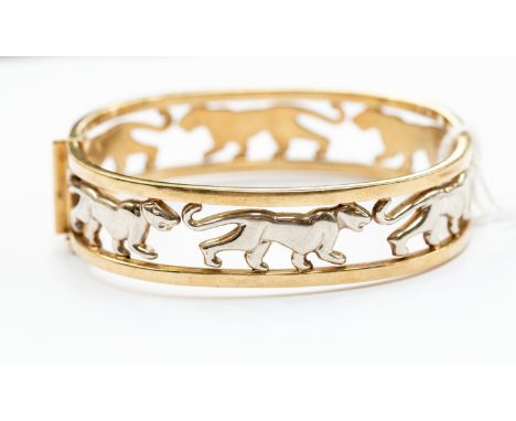 A 9ct gold two tone open bangle with white gold inset panthers, hinged, internal diameter approx 60mm, total gross weight app