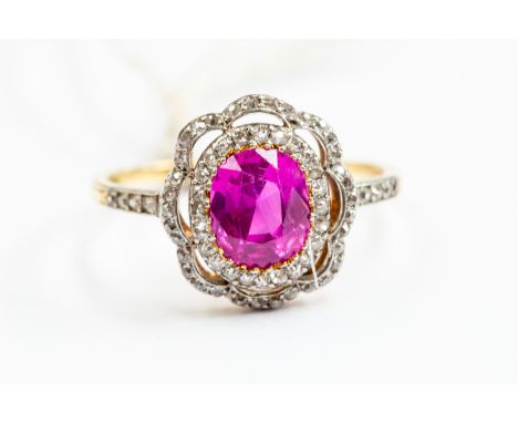 A synthetic ruby and diamond dress ring, with openwork flower design set with grain set diamonds, and diamond set shoulders, 