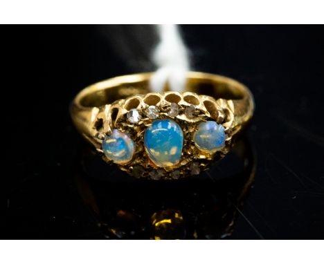 An 18ct gold opal three-stone ring, diamonds points, size J½m gross weight approx 3gms