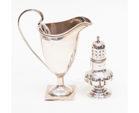 A helmet shaped silver cream jug, Chester 1899 together with a silver pepperette, (2)