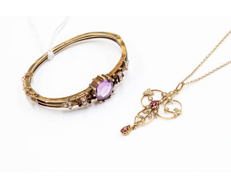 An Edwardian amethyst and pearl hinged bangle, unmarked tests as approx 9ct gold, total gross weight approx 13.8gms; and an E
