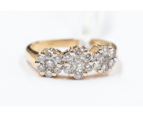 A diamond cluster set dress ring, comprising three cluster settings set with brilliant cut diamonds, 18ct gold, size K diamon