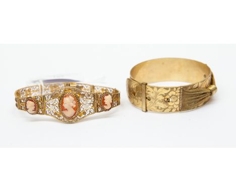 Two bracelets comprising a belt style cuff bangle and a cameo set yellow metal bracelet