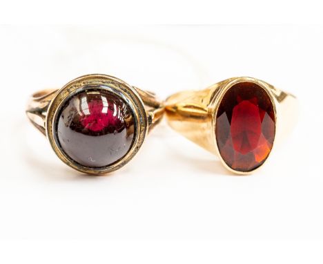 A garnet cabochon 9ct gold ring, size M, along with a faceted oval garnet and 9ct gold ring, size O, combined total gross wei