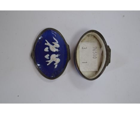 A Bilston cobalt blue enamel snuff box with raised pattern of two love birds in white.