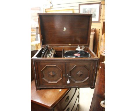 A Mid 20th Century oak Apollo marked HMV Record Player, with a collection of records.