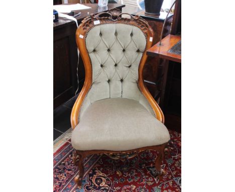 Victorian reproduction button back nursing chair with green upholstery.