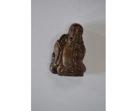 A treen netsuke in the form of Hotei, signed