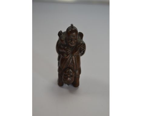 A treen netsuke of two acrobats, signed